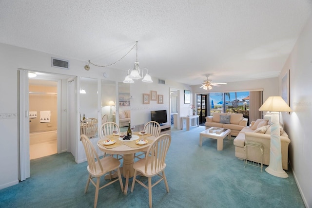 6357 Bahia Del Mar Blvd Unit 111, Saint Petersburg, FL 33715 - carpeted dining area featuring visible vents, a textured ceiling, and ceiling fan with notable chandelier