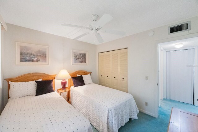6357 Bahia Del Mar Blvd Unit 111, Saint Petersburg, FL 33715 - carpeted bedroom with a ceiling fan, baseboards, visible vents, and a closet