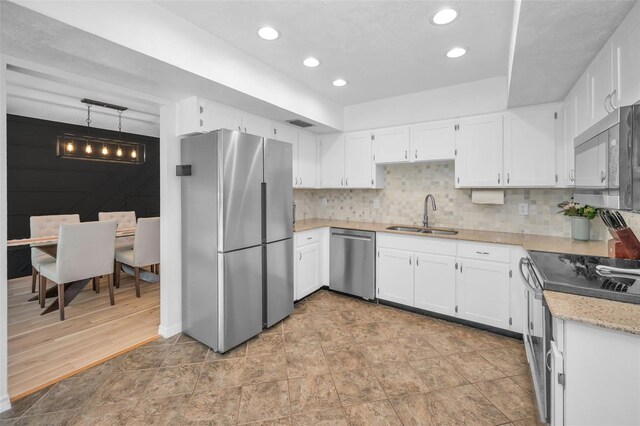 613 Valley Hill Dr, Brandon, FL 33510 - kitchen featuring appliances with stainless steel finishes, a sink, white cabinetry, backsplash, and recessed lighting
