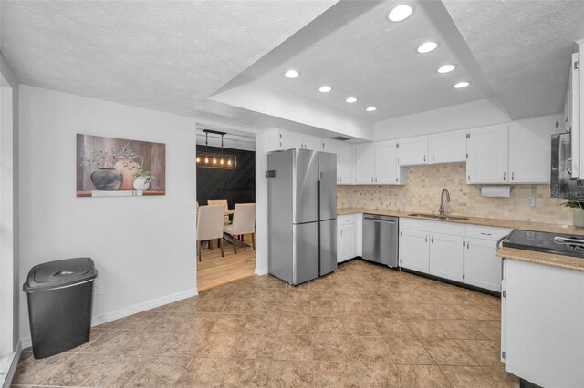 613 Valley Hill Dr, Brandon, FL 33510 - kitchen with appliances with stainless steel finishes, a sink, recessed lighting, a textured ceiling, and white cabinets