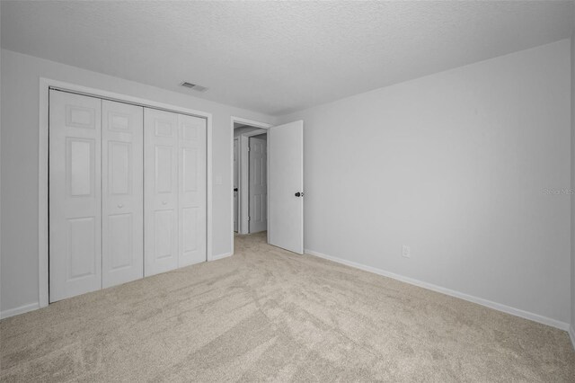 613 Valley Hill Dr, Brandon, FL 33510 - unfurnished bedroom with carpet flooring, a textured ceiling, a closet, and baseboards
