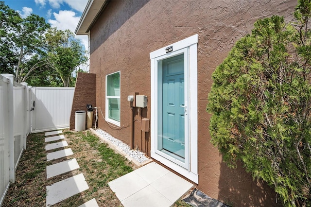 613 Valley Hill Dr, Brandon, FL 33510 - property entrance featuring stucco siding and a gate