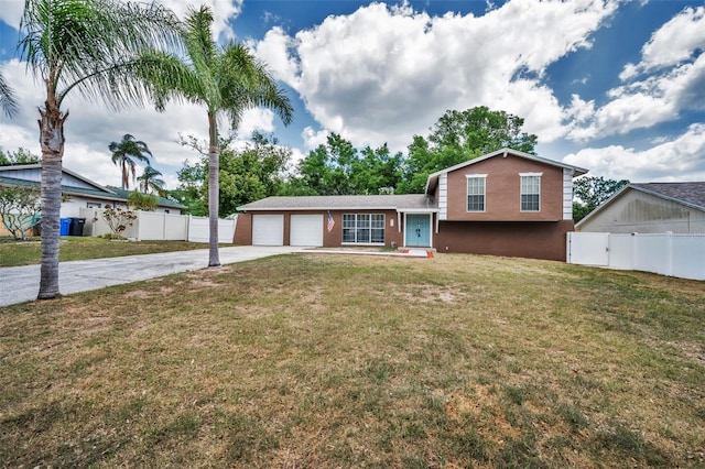 613 Valley Hill Dr, Brandon, FL 33510 - tri-level home with driveway, a garage, and stucco siding