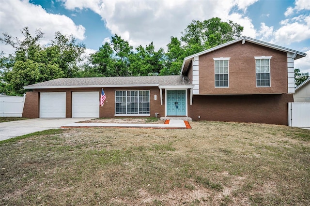 613 Valley Hill Dr, Brandon, FL 33510 - tri-level home with concrete driveway, a garage, and stucco siding