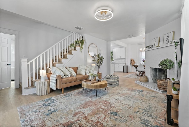 3000 19th Ave S, Saint Petersburg, FL 33712 - living area with stairs, wood finished floors, and a fireplace with raised hearth