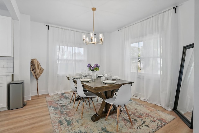 3000 19th Ave S, Saint Petersburg, FL 33712 - dining room featuring a chandelier, light wood-style flooring, plenty of natural light, and baseboards