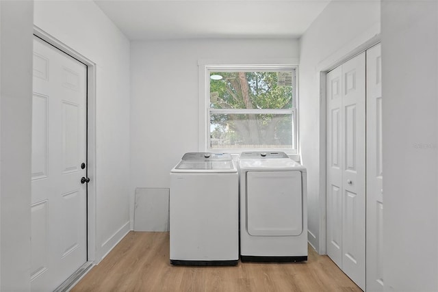 3000 19th Ave S, Saint Petersburg, FL 33712 - washroom featuring independent washer and dryer, light wood-style flooring, and baseboards