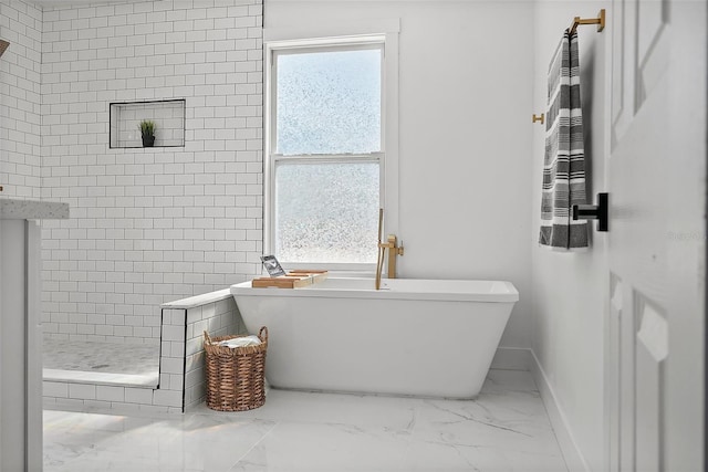 3000 19th Ave S, Saint Petersburg, FL 33712 - full bath with marble look tile flooring, a stall shower, a soaking tub, and baseboards