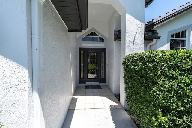 property entrance featuring stucco siding