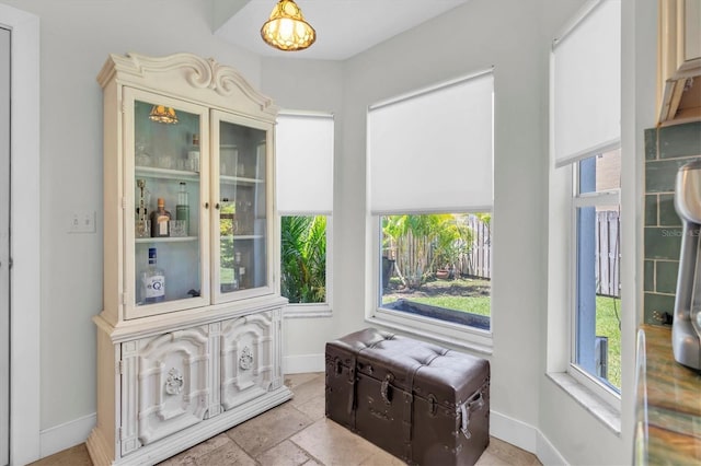 interior space featuring baseboards and a wealth of natural light