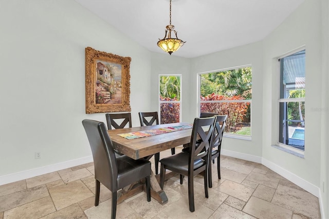 dining space with stone tile flooring and baseboards