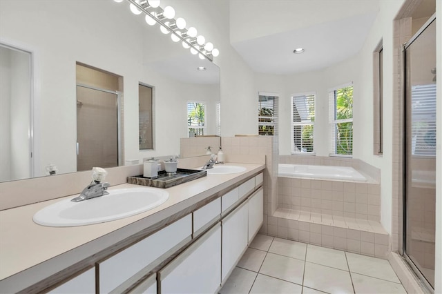 bathroom featuring a shower stall, tile patterned flooring, and a sink