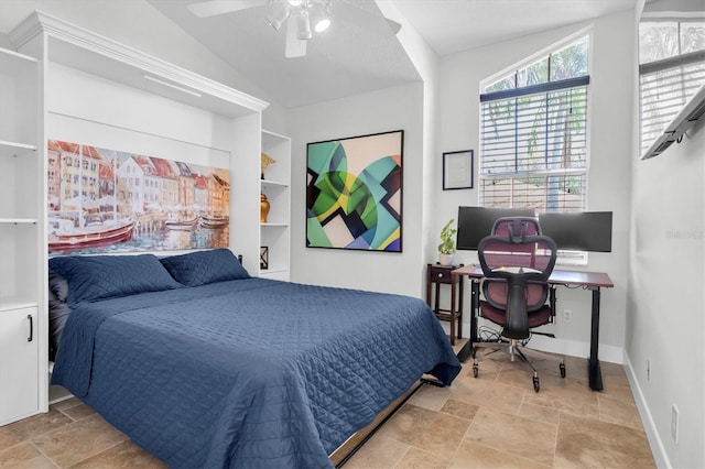 bedroom with stone tile floors, ceiling fan, baseboards, and lofted ceiling