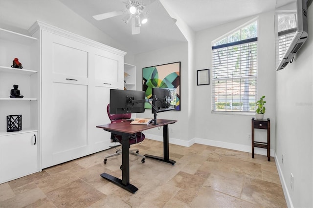 office area featuring ceiling fan, baseboards, stone tile floors, and vaulted ceiling