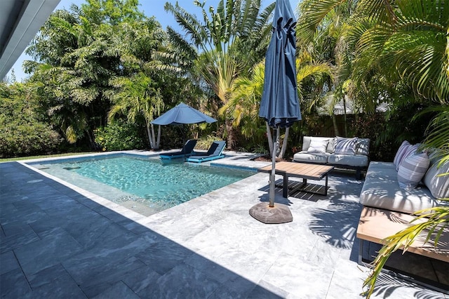 pool with an outdoor hangout area and a patio