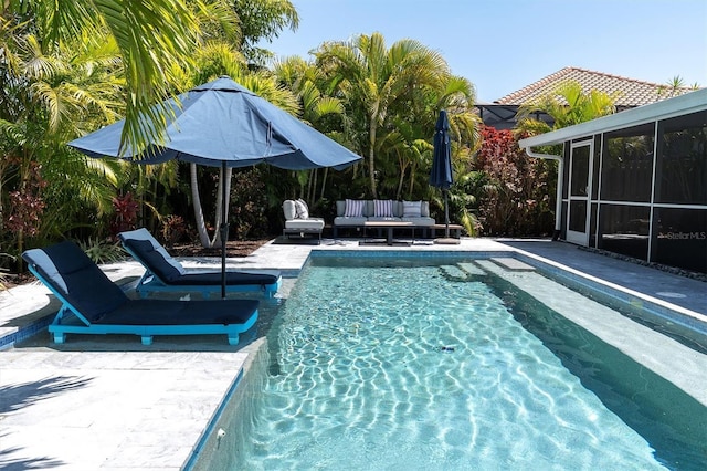 pool with an outdoor hangout area and a patio area