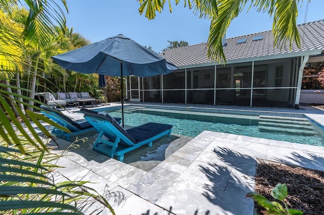 pool featuring a sunroom, an outdoor living space, and a patio