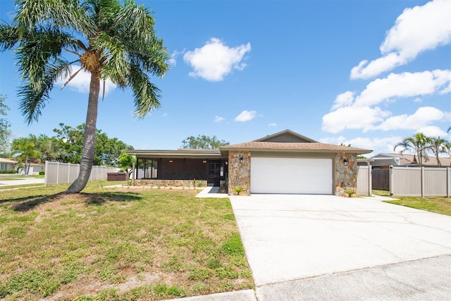 11797 David Ct, Largo, FL 33778 - view of front of property featuring stone siding, driveway, and an attached garage