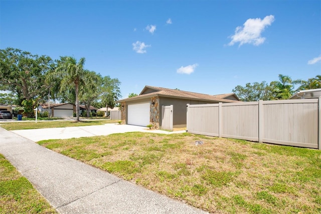 11797 David Ct, Largo, FL 33778 - view of side of home with concrete driveway, an attached garage, and stucco siding