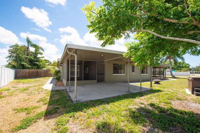 11797 David Ct, Largo, FL 33778 - back of house featuring a fenced backyard, a patio area, and a sunroom