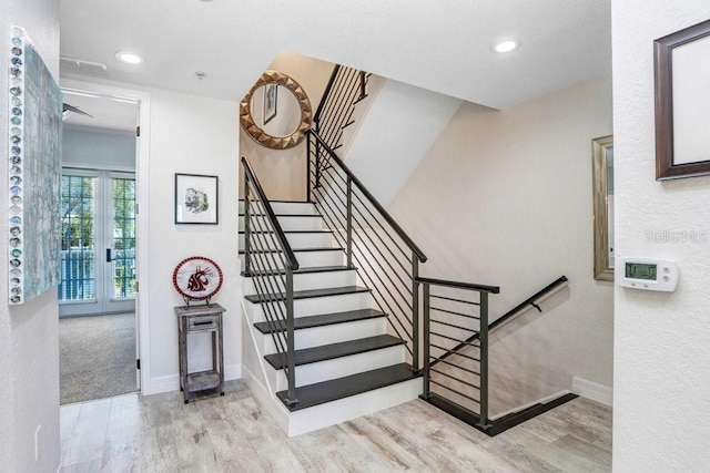 stairway with recessed lighting, wood finished floors, and baseboards