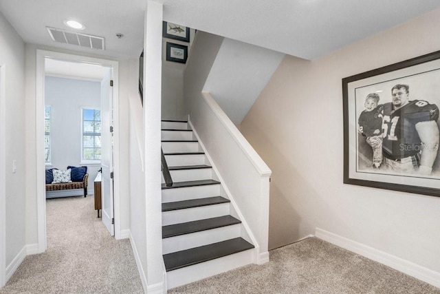stairway with carpet, visible vents, and baseboards