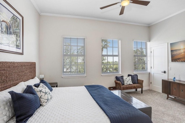 carpeted bedroom featuring ceiling fan, ornamental molding, and baseboards