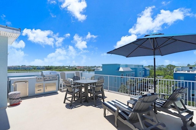 view of patio with exterior kitchen, area for grilling, and outdoor dining area