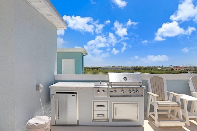 view of patio / terrace featuring area for grilling and exterior kitchen