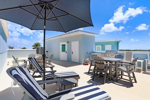 view of patio with outdoor dining area and area for grilling