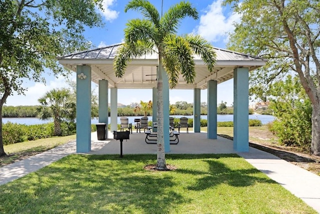 view of community with a gazebo, a yard, and a water view