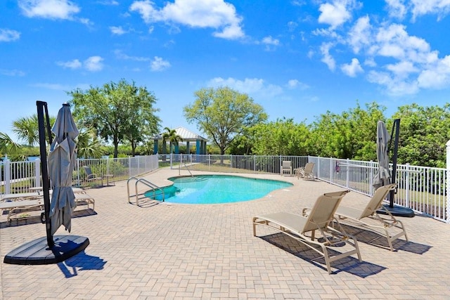 community pool featuring a patio and fence