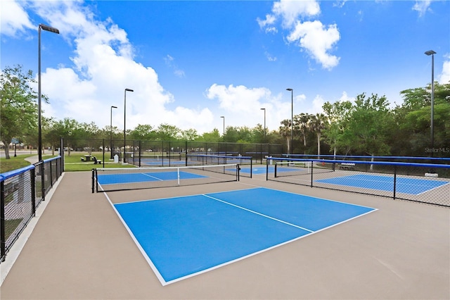 view of tennis court featuring fence