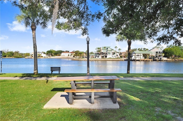 surrounding community featuring a water view, a yard, and a residential view