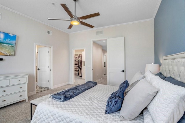 carpeted bedroom featuring baseboards, visible vents, and ornamental molding