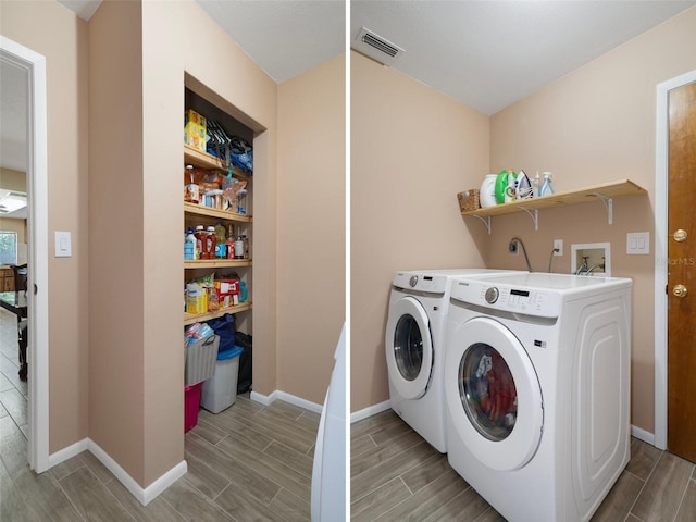 washroom featuring visible vents, wood finish floors, independent washer and dryer, and laundry area