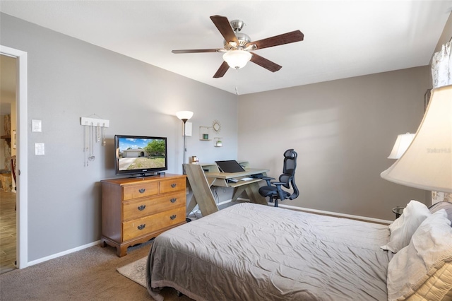 bedroom with a ceiling fan, baseboards, and carpet floors