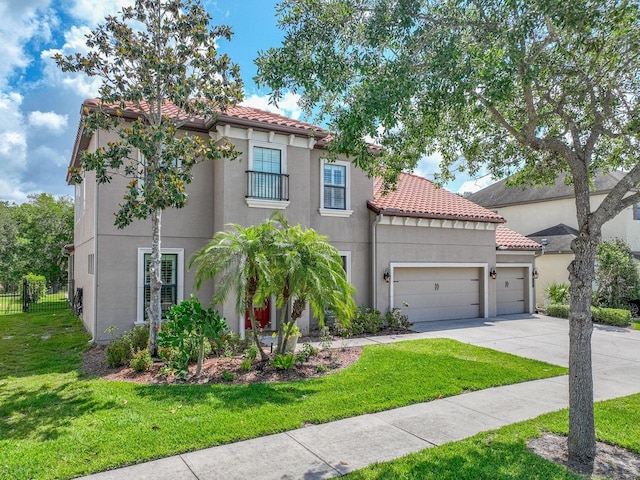 mediterranean / spanish-style home with fence, an attached garage, a tile roof, stucco siding, and concrete driveway