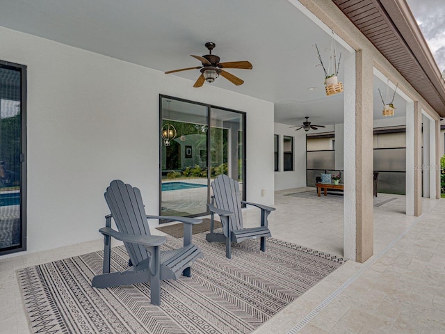 view of patio / terrace featuring a ceiling fan and an outdoor pool