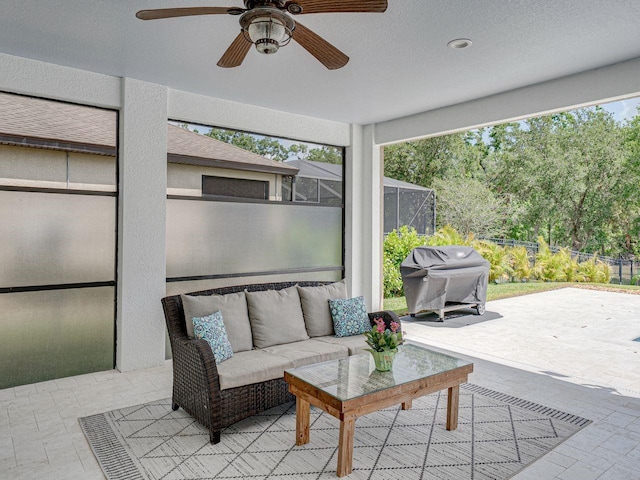 view of patio / terrace with fence, ceiling fan, an outdoor living space, a lanai, and a grill