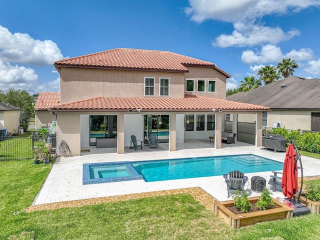 back of property with a lawn, a fenced backyard, a patio area, and stucco siding