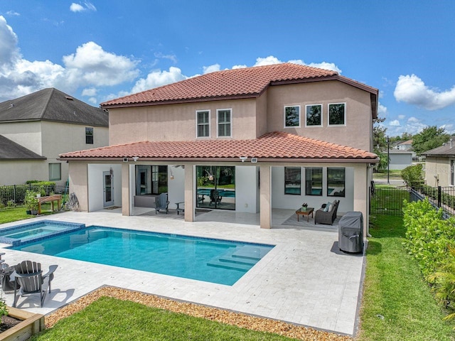 back of property with a fenced backyard, stucco siding, an outdoor living space, and a patio area