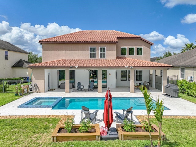 rear view of house featuring a patio area, stucco siding, a yard, and fence