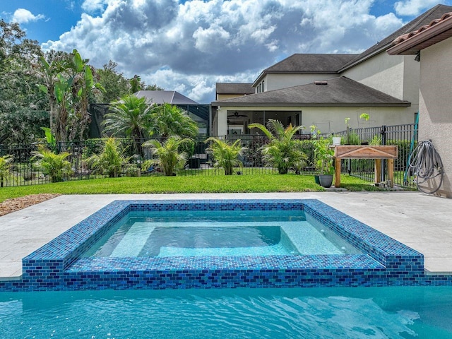 view of pool featuring a lawn, fence, and a patio area