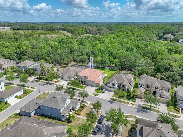 birds eye view of property featuring a residential view and a view of trees
