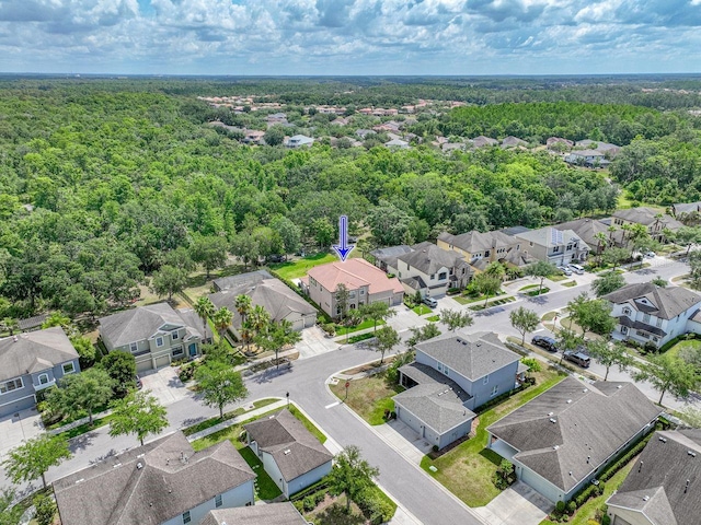 birds eye view of property with a residential view and a wooded view