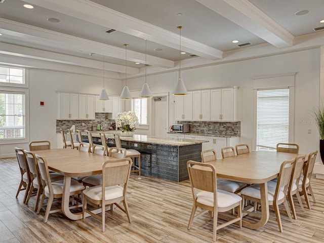 dining area with crown molding, recessed lighting, beamed ceiling, and light wood finished floors