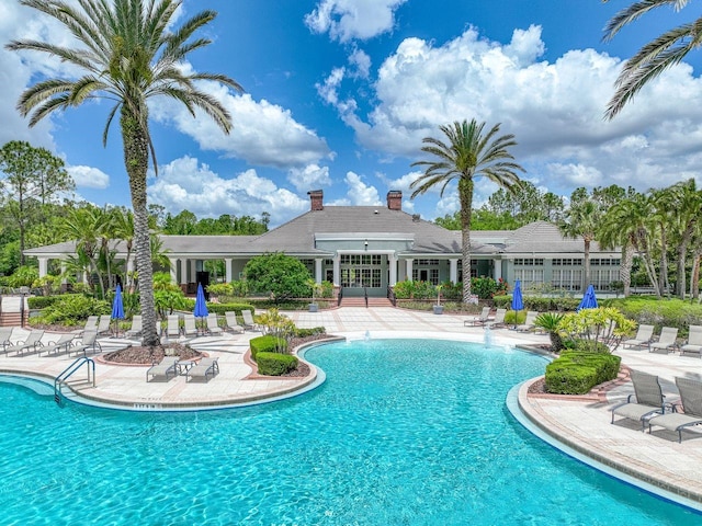 community pool with a patio and french doors