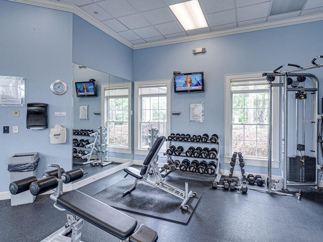 workout area featuring baseboards and ornamental molding