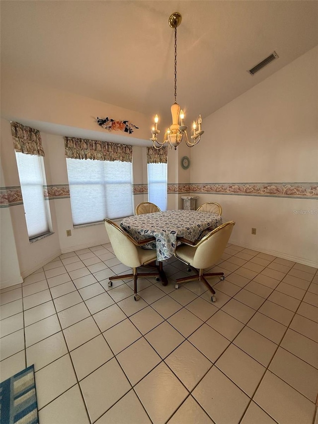 1695 Stable Trl, Palm Harbor, FL 34685 - dining area featuring light tile patterned floors, vaulted ceiling, a chandelier, and visible vents